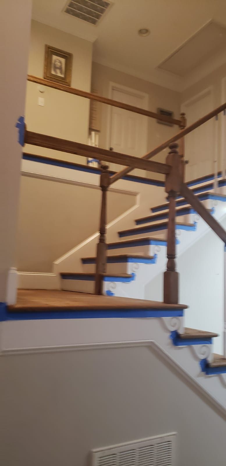 A staircase is being painted in a house.