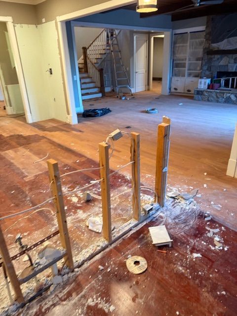 A room that is being remodeled with a ladder on the floor.