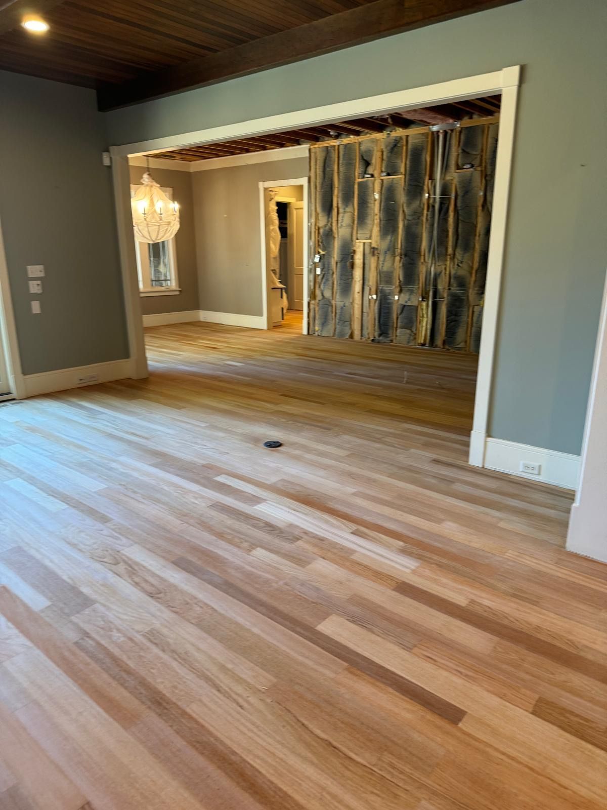 A living room with hardwood floors and a sliding glass door.