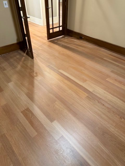 A room with a wooden floor and a door.