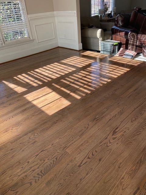 A living room with hardwood floors and a couch