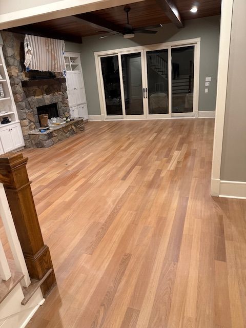 A living room with hardwood floors and a fireplace