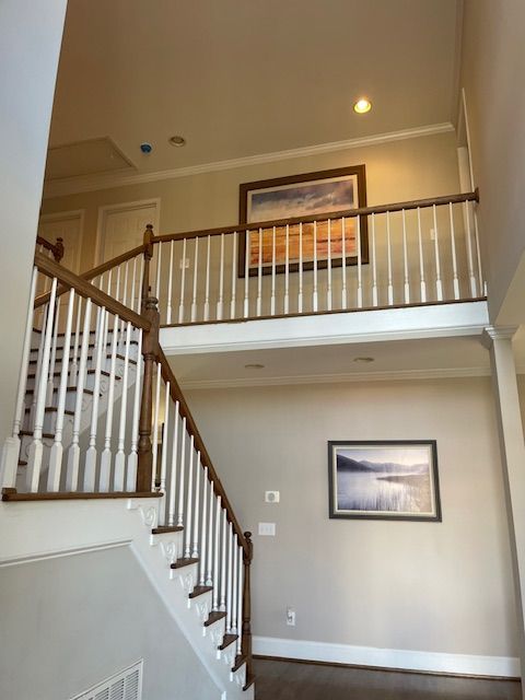 A staircase with a picture on the wall above it