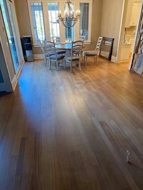 A dining room with a table and chairs and a chandelier.