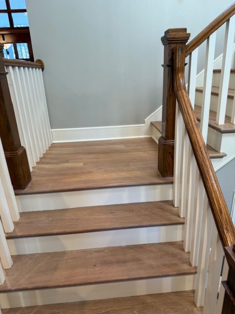 A staircase with wooden steps and a white railing