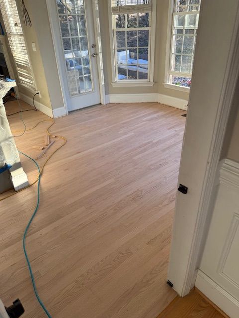 A room with hardwood floors and a vacuum cleaner in it