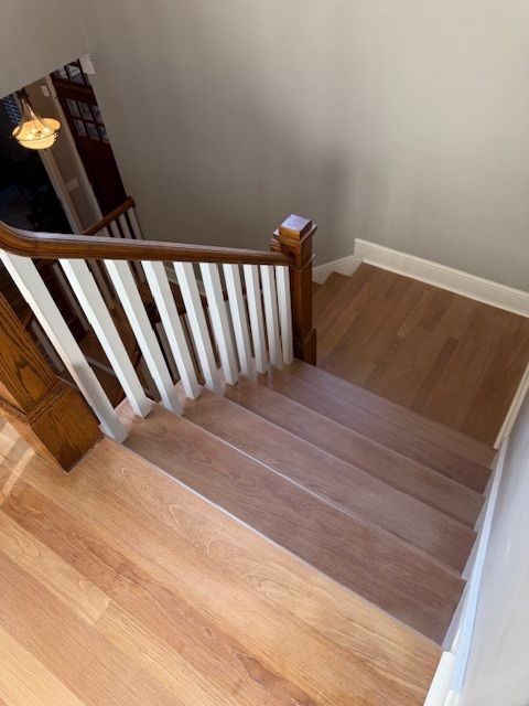 A staircase with wooden steps and a white railing