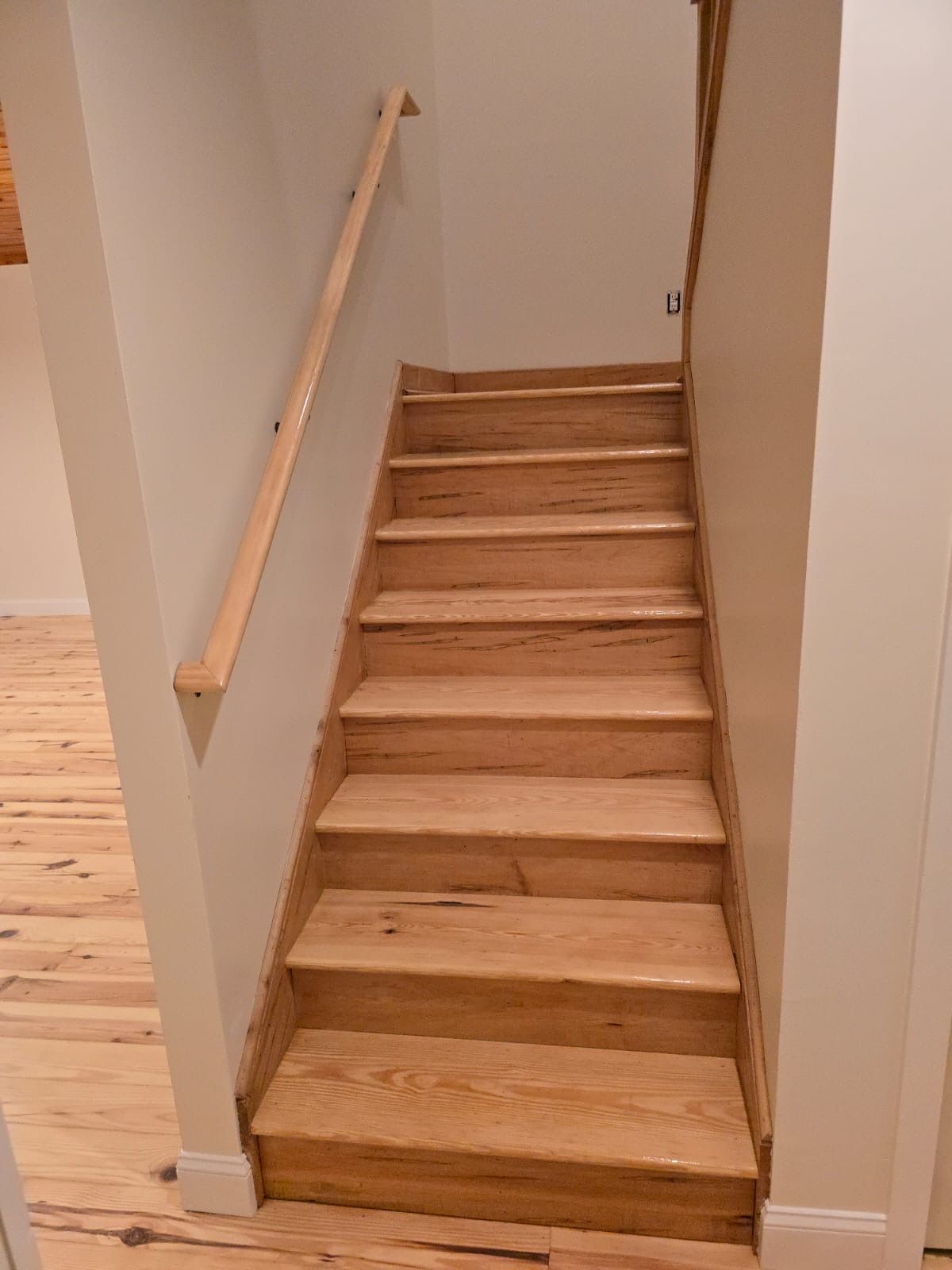 The stairs are made of wood and have a wooden railing.