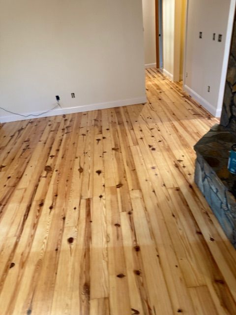 A living room with hardwood floors and a fireplace