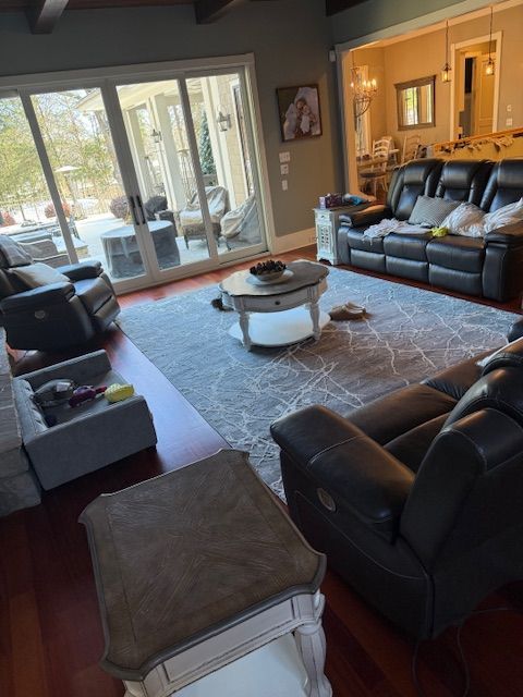 A living room with a couch and chairs and a coffee table