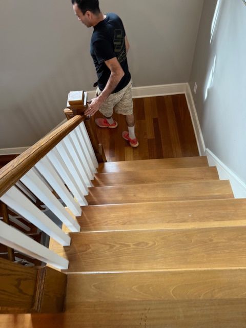 A man is standing on a set of wooden stairs