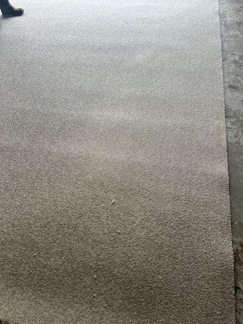 A person is walking on a carpeted floor.