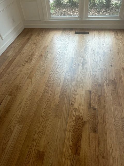 A room with hardwood floors and a window.