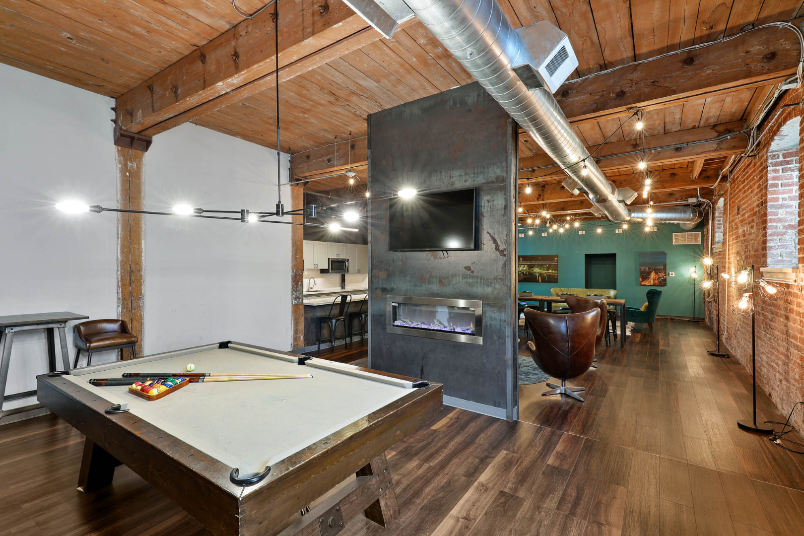 There is a pool table in the middle of the room.