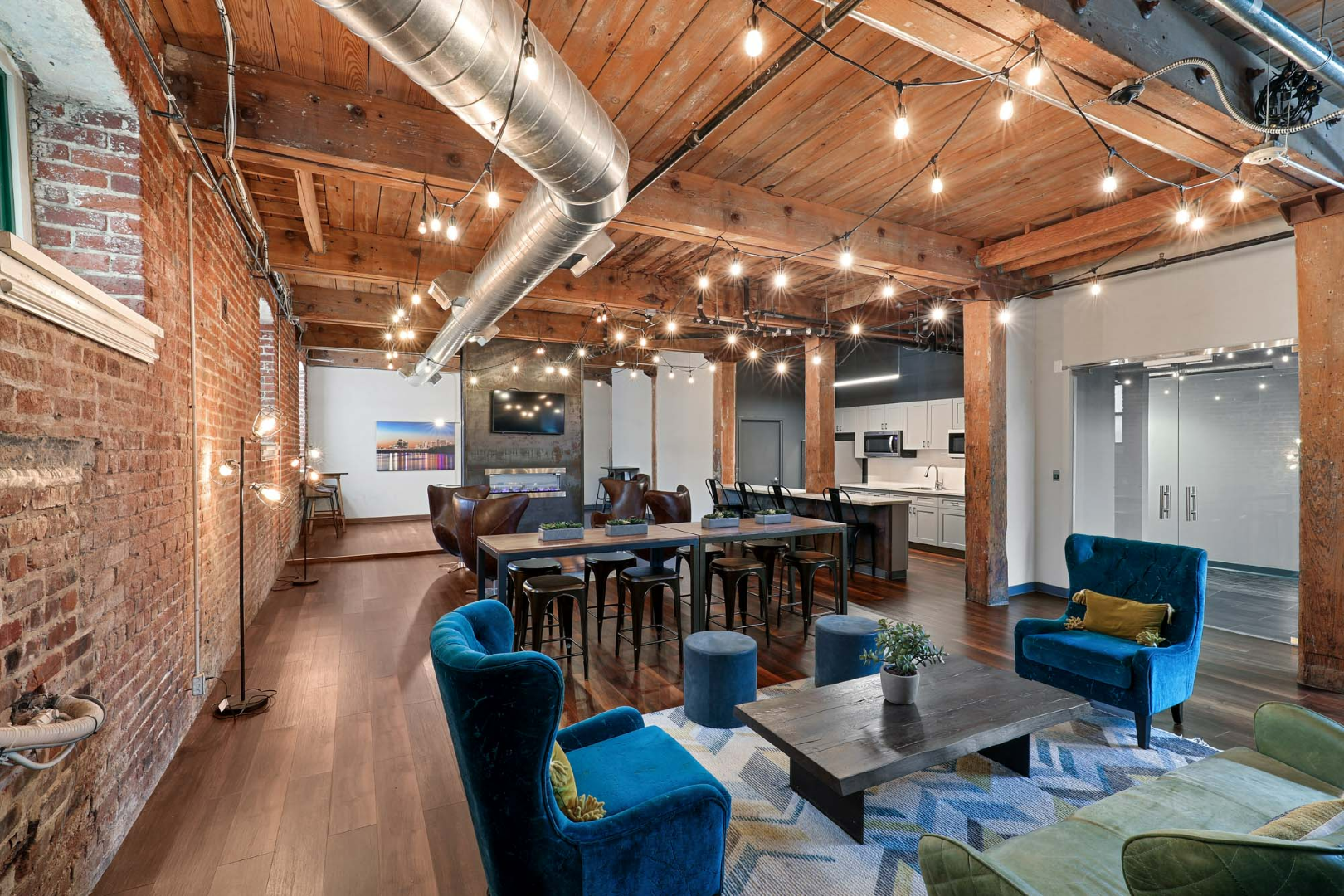 A large room with a lot of furniture and a brick wall.