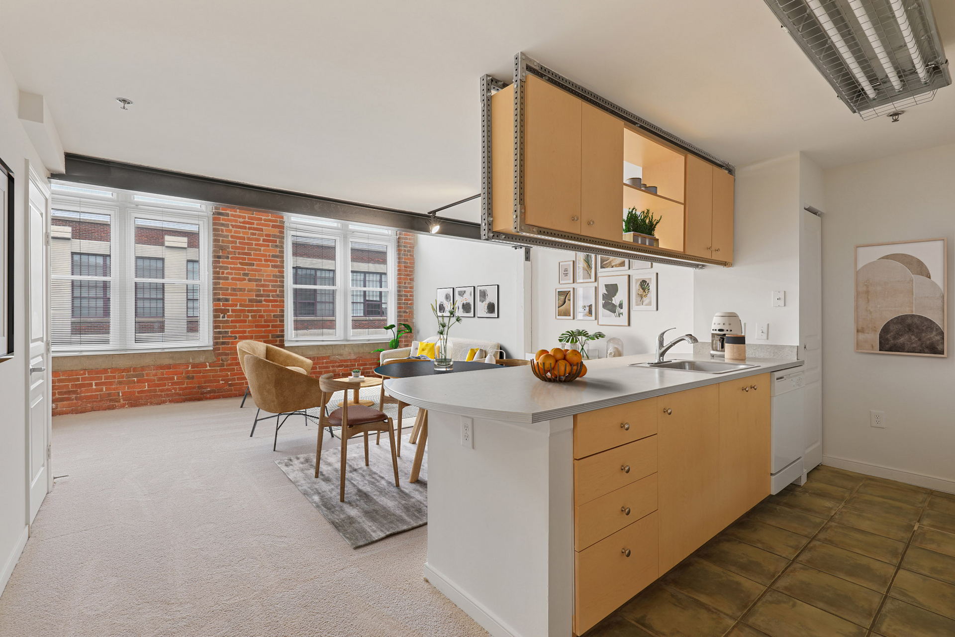 A kitchen with wooden cabinets and a large island in the middle of the room.