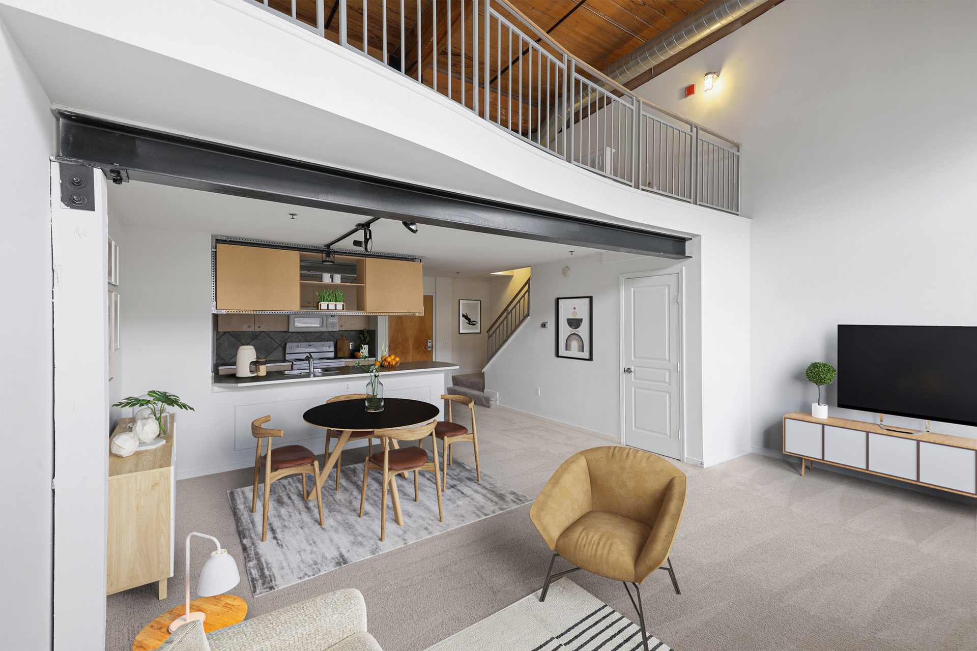 A living room with a dining table and chairs and a flat screen tv.