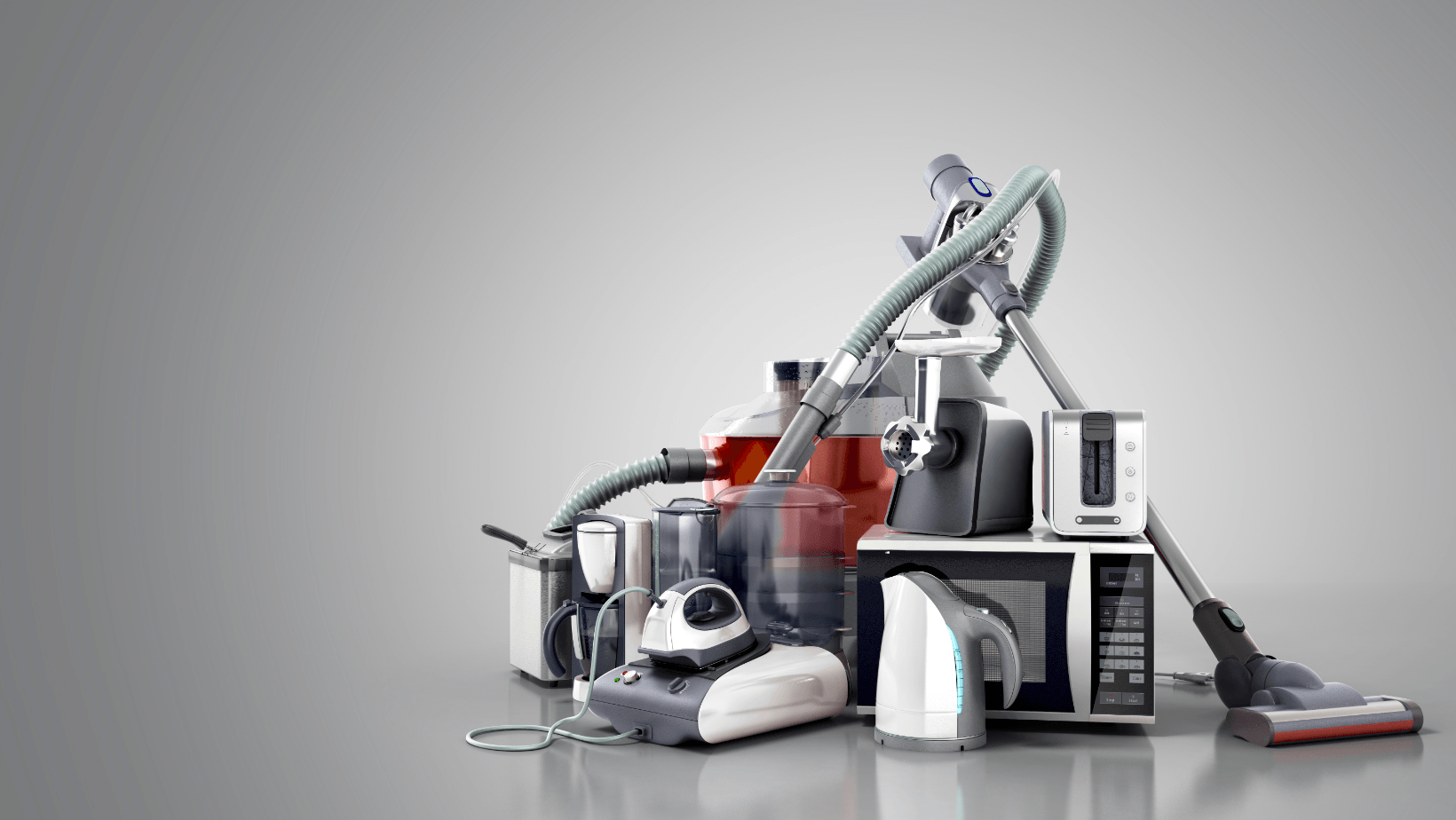 A pile of household appliances stacked on top of each other on a table.