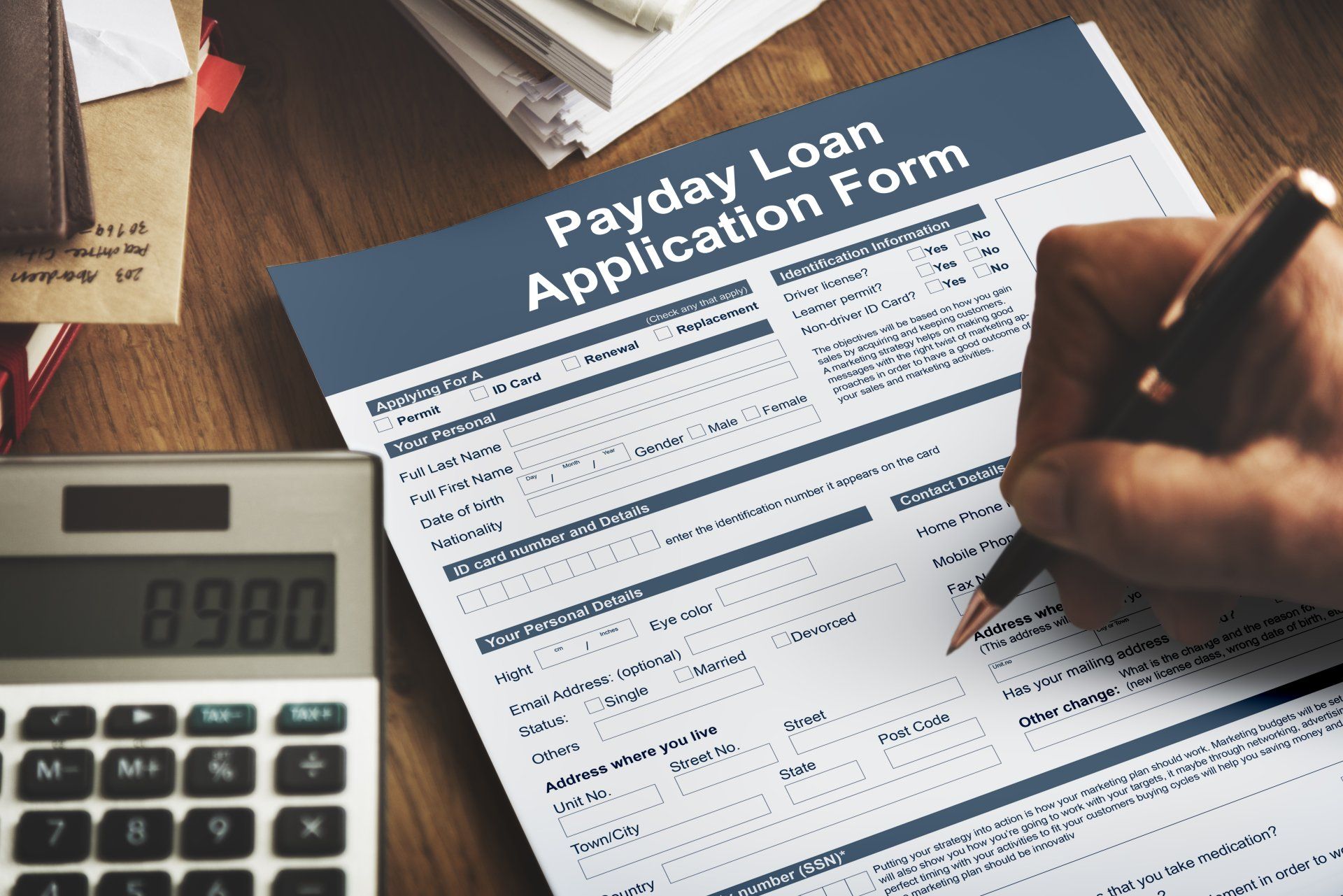 A person is filling out a payday loan application form
