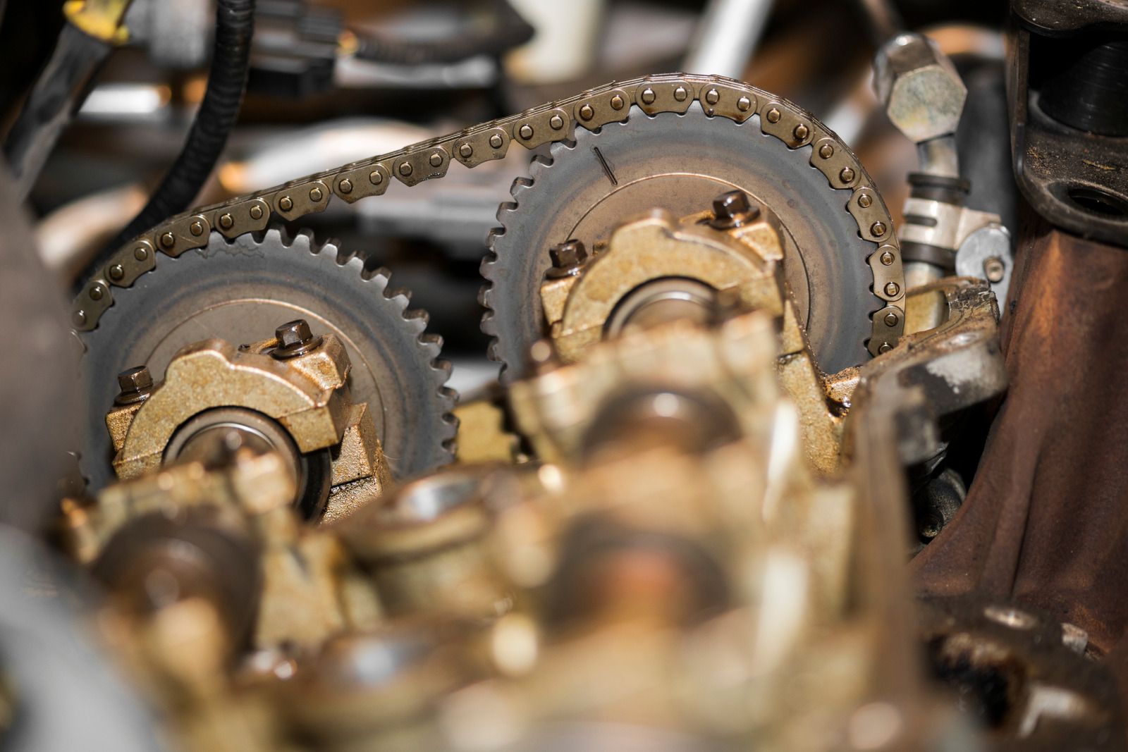 Close-up of engine gears and chain, showing engine components, possibly for repair.