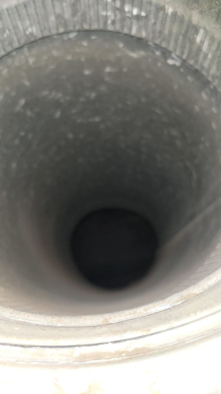 A close up of a metal pipe with a hole in the middle.