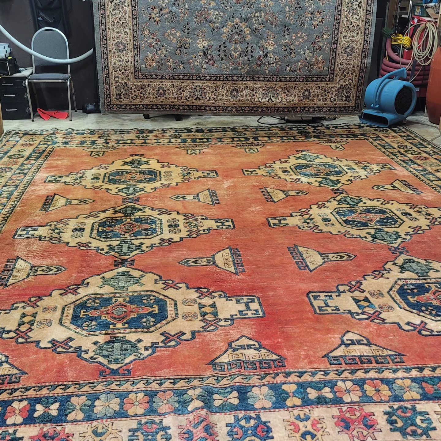 A large rug is sitting on the floor in a room