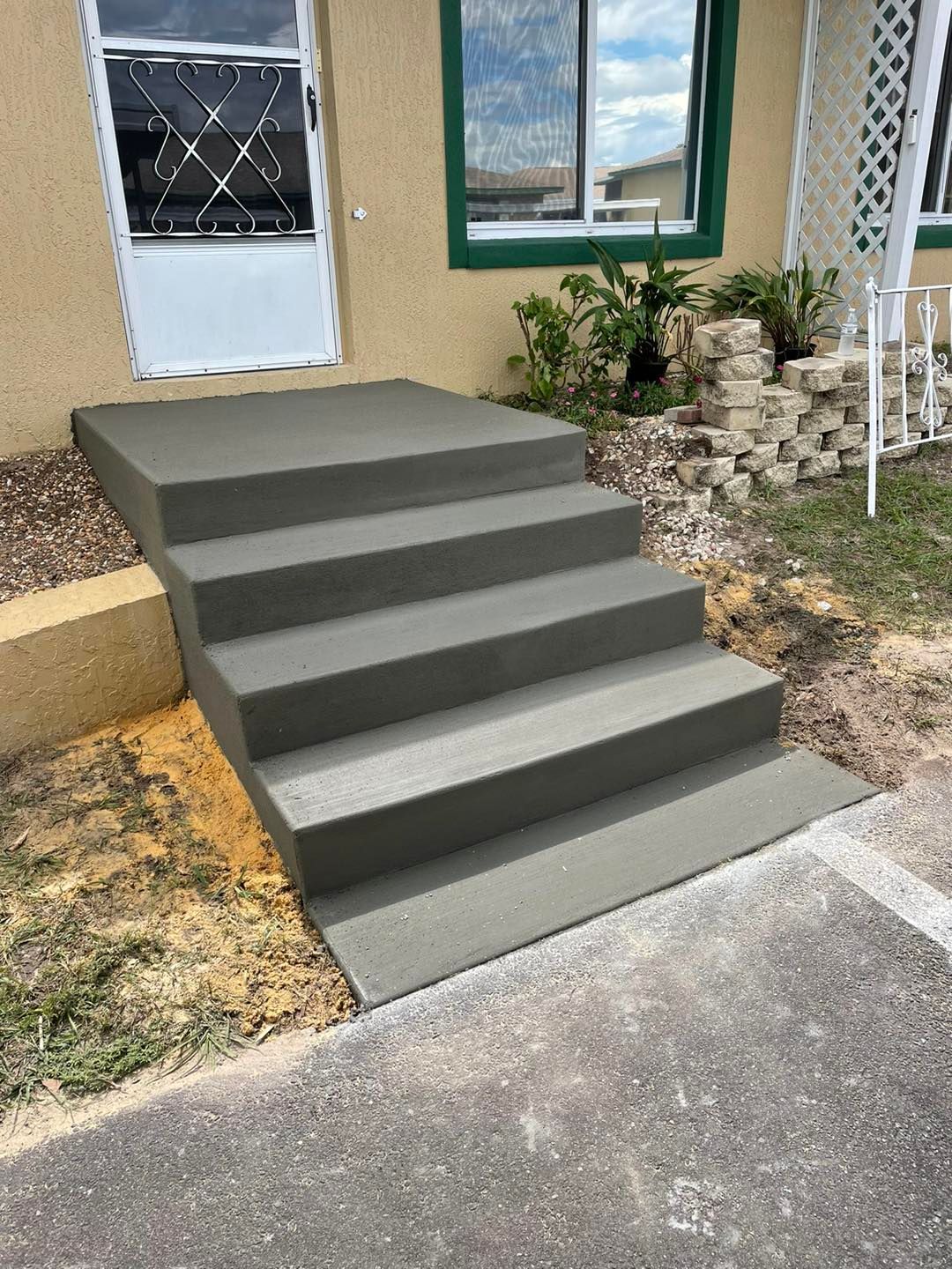 A set of concrete steps leading up to a house.