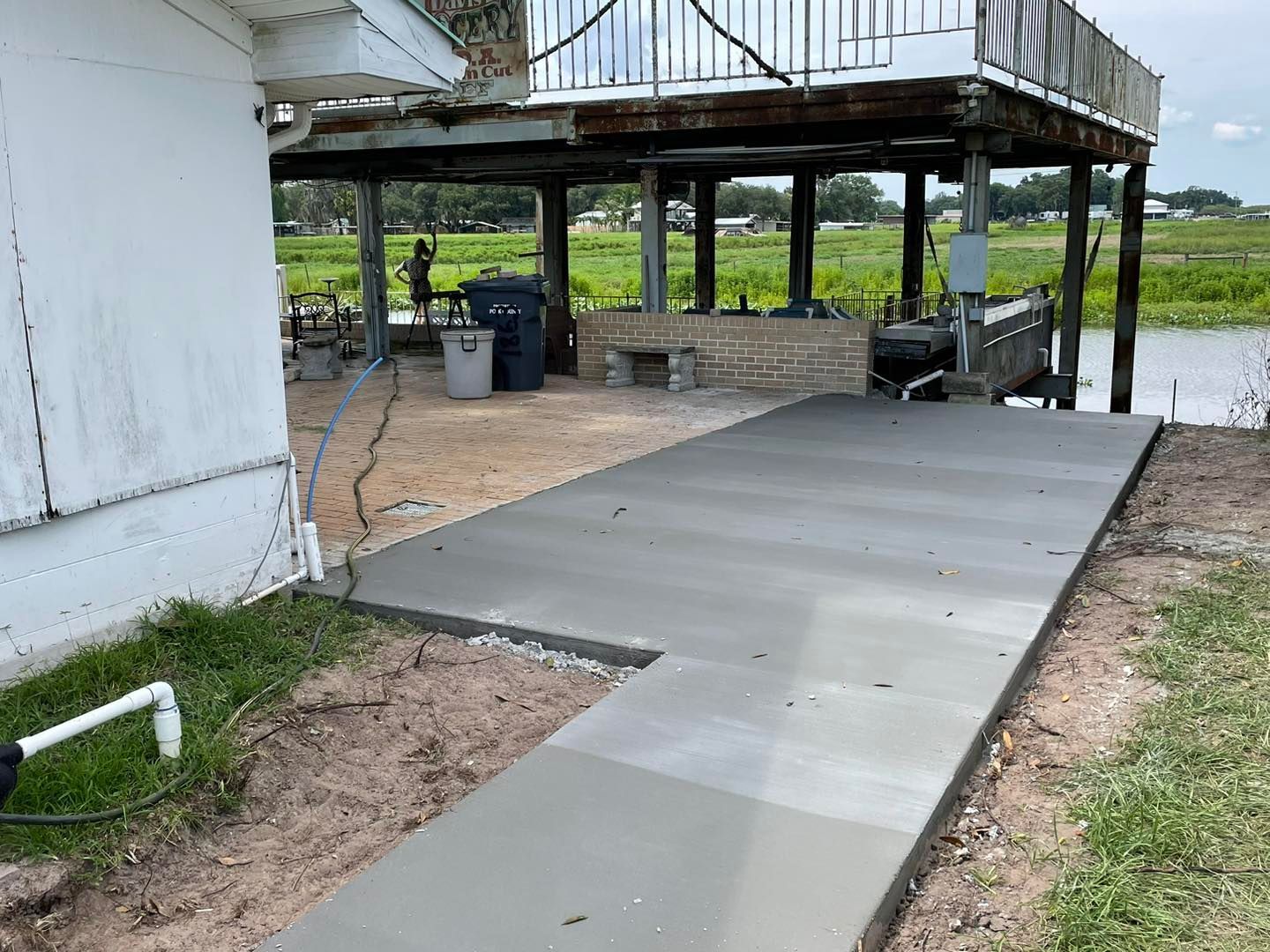 A concrete walkway is being built in front of a house.
