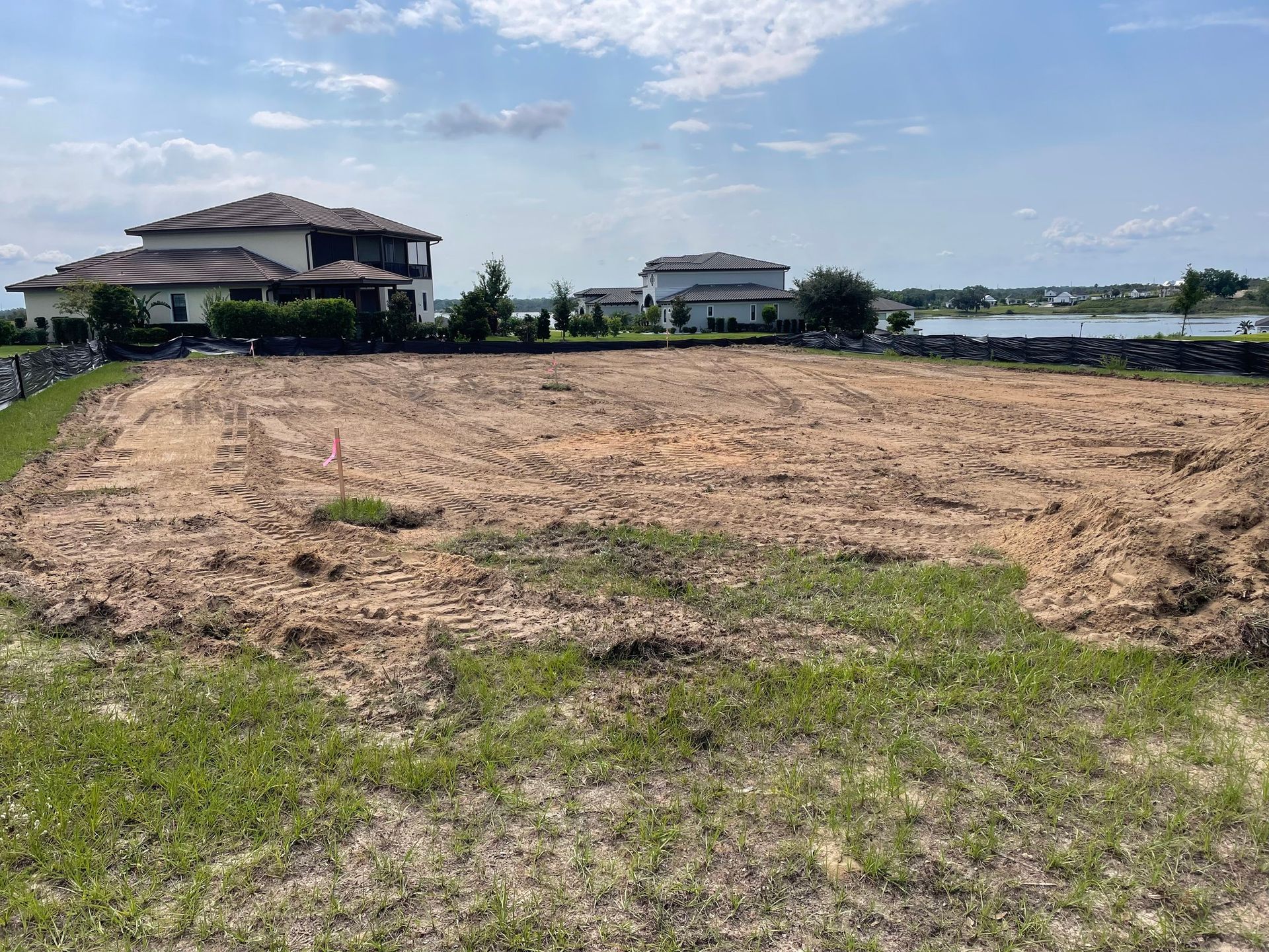 A large empty field with a house in the background.