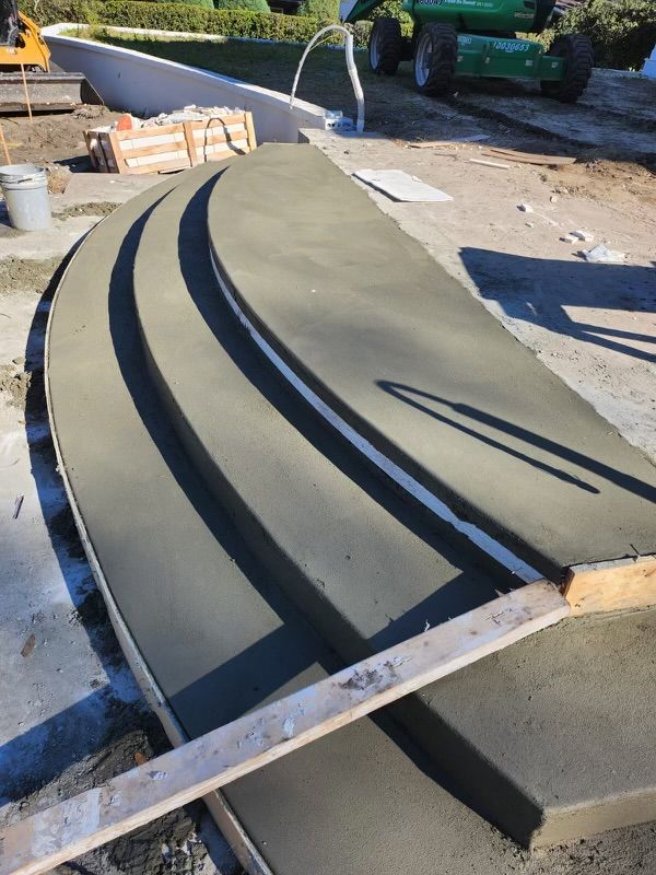 A curved piece of concrete is sitting on the ground