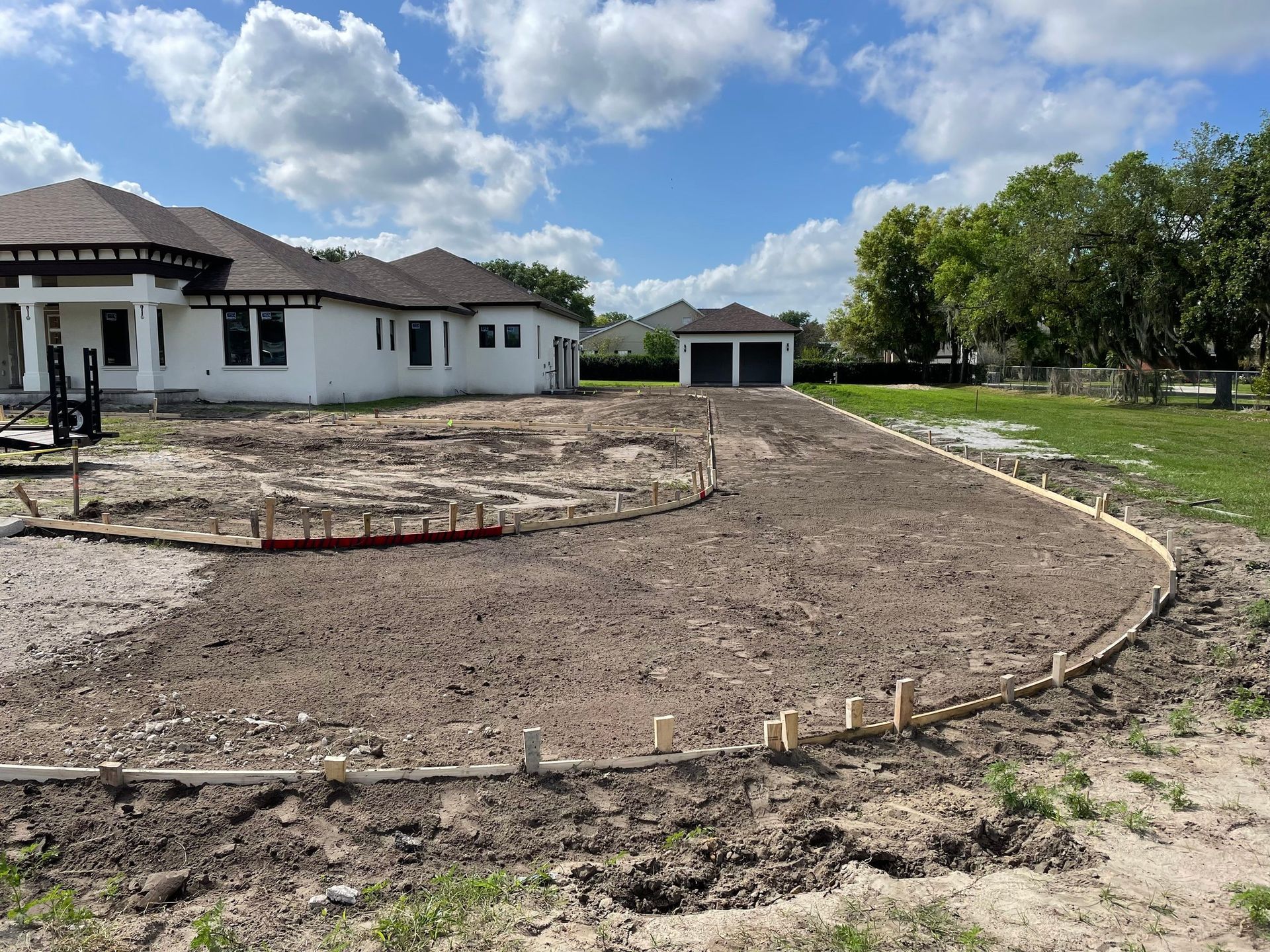 A house is being built in the middle of a dirt field.