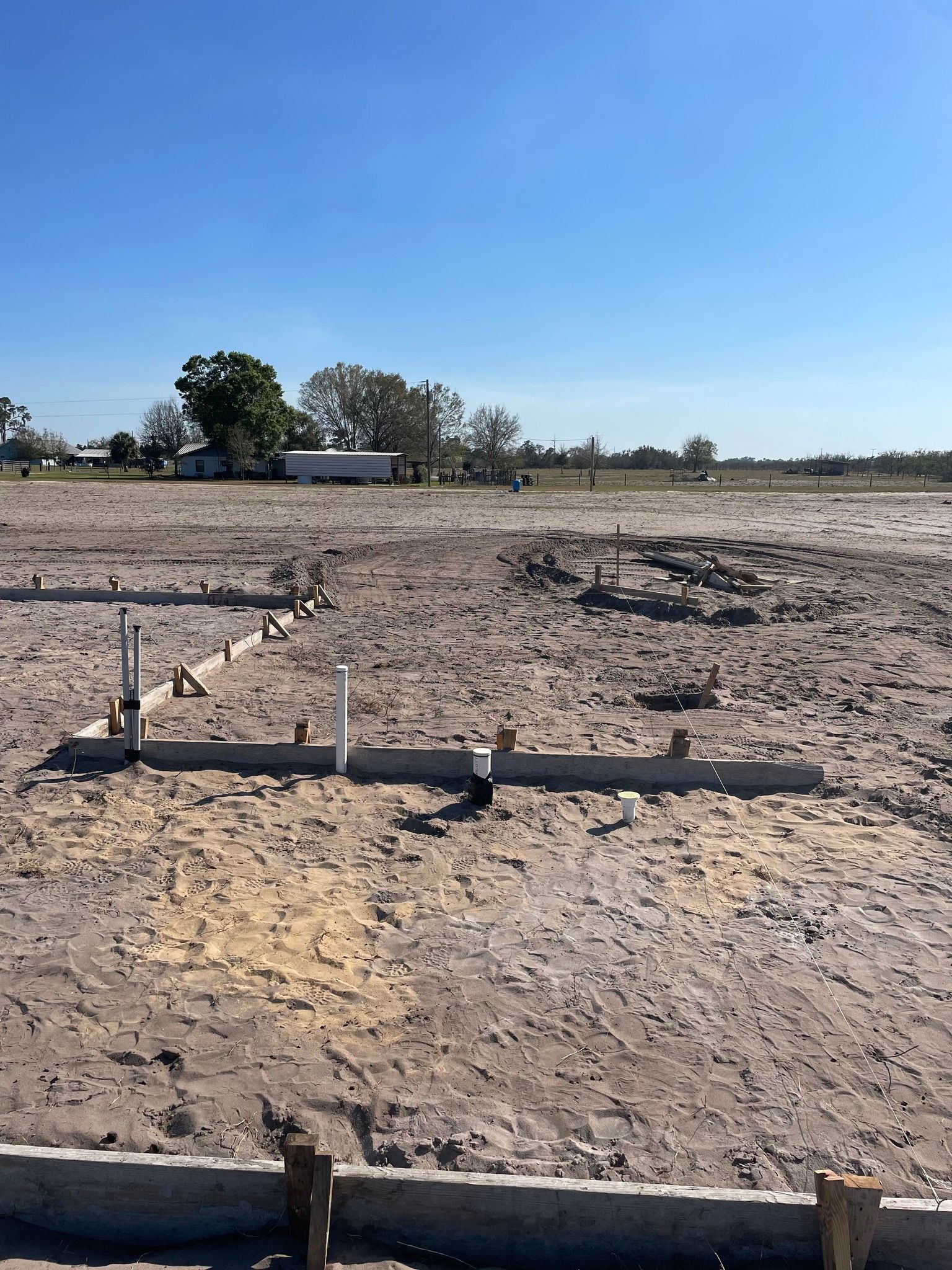 A dirt field with a blue sky in the background.
