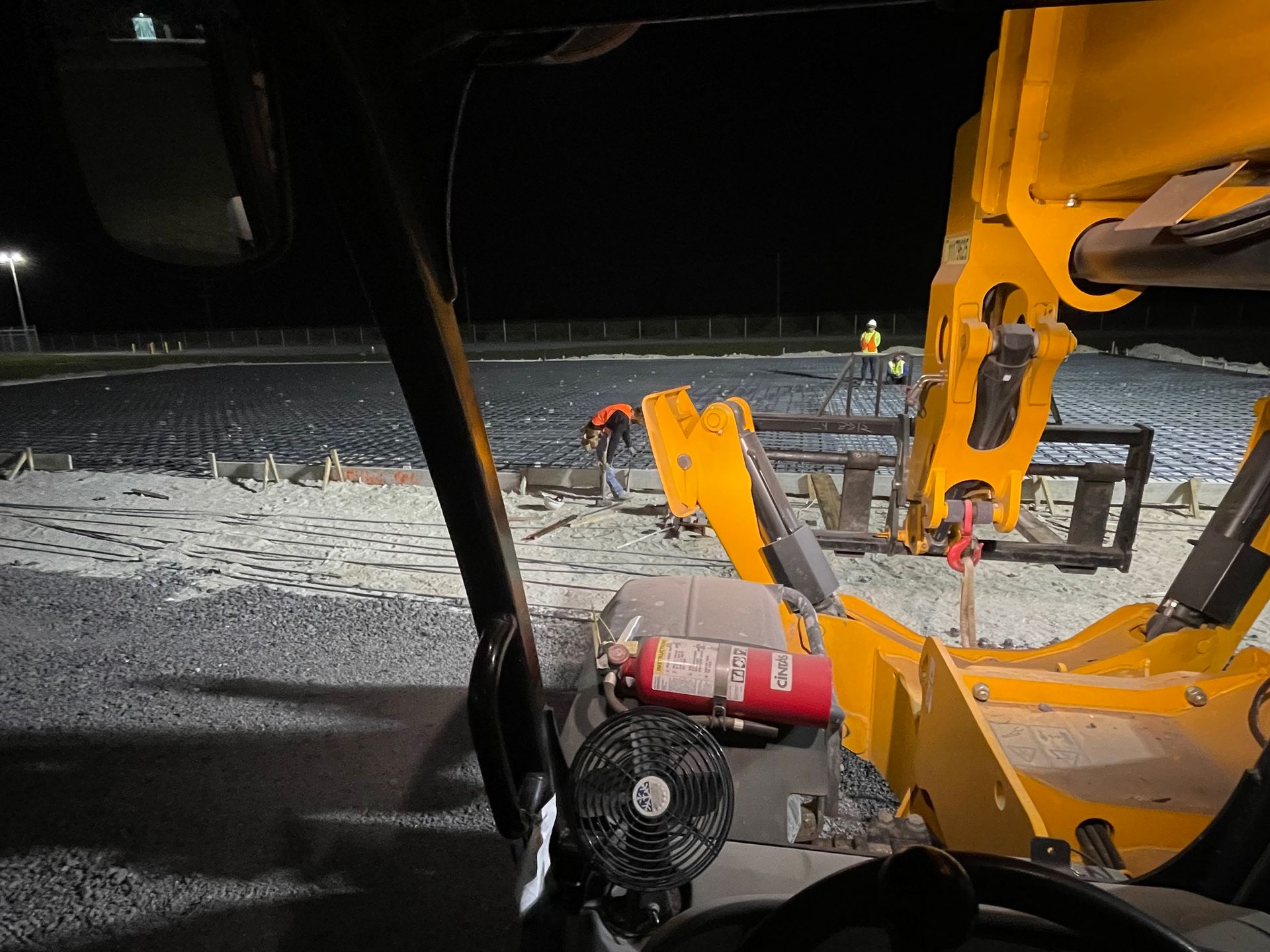 A view of a construction site from inside a vehicle at night