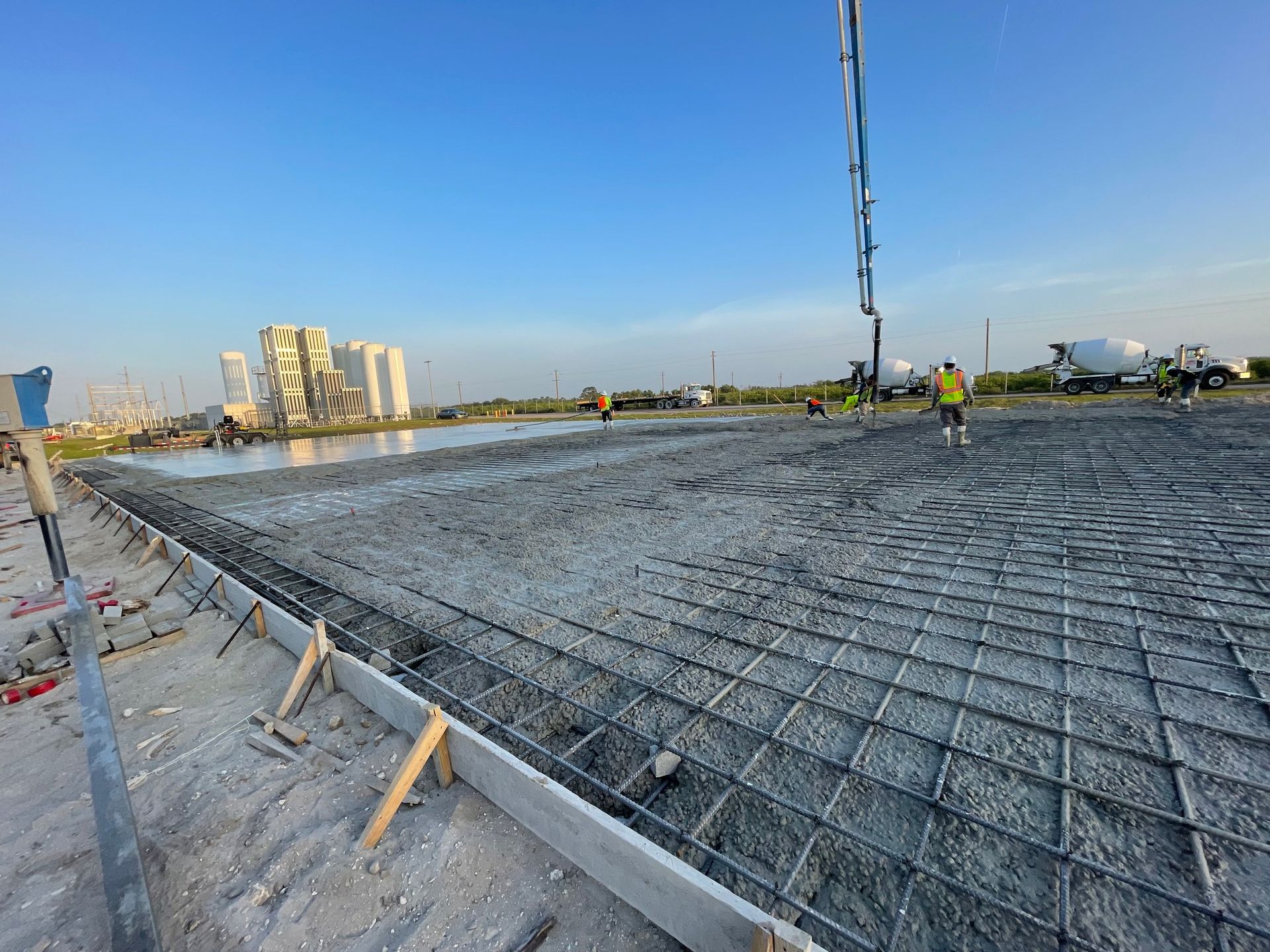 A concrete pump is being used to pour concrete on a construction site.