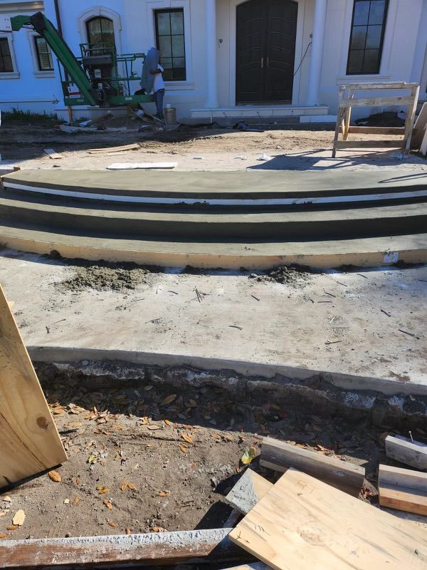 A concrete staircase is being built in front of a house.