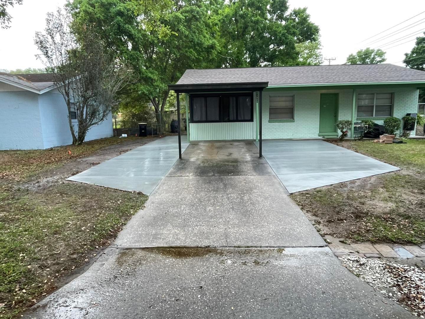 A house with a concrete driveway leading to it