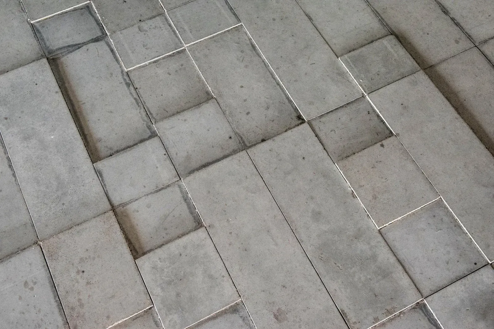 A close up of a concrete floor with a pattern of squares