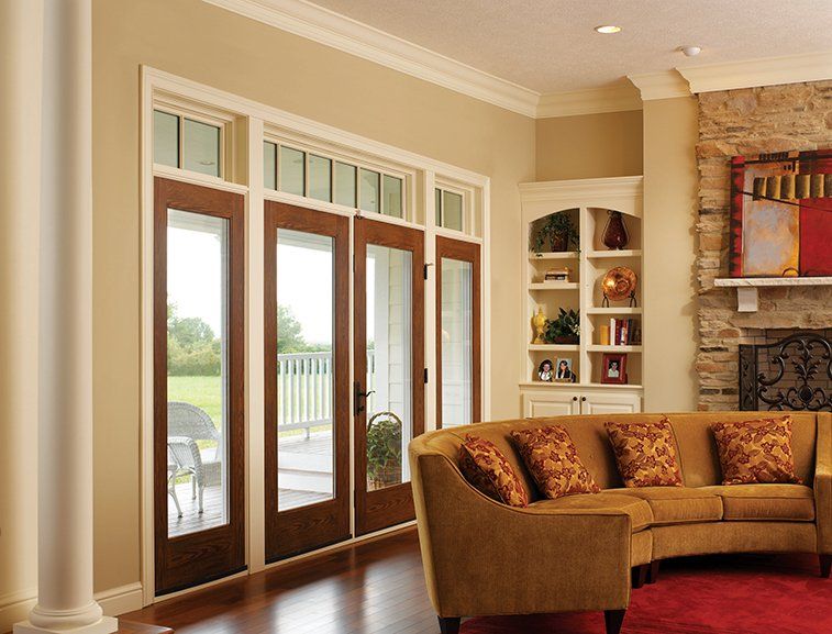 A living room with a couch and sliding glass doors