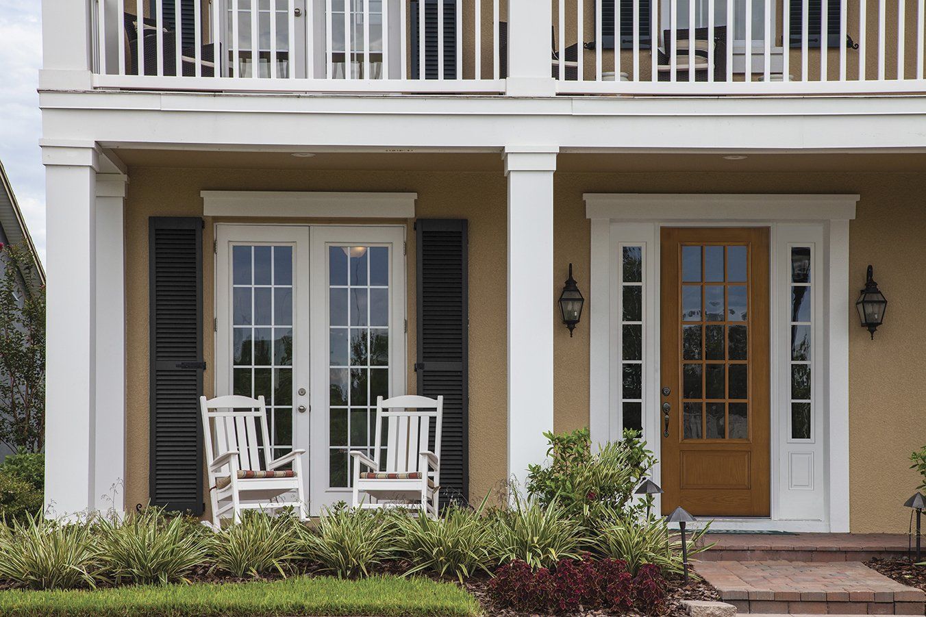 A house with a porch and two rocking chairs on it