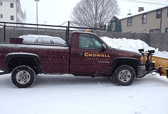 Commercial Snow Removal Vehicle and Plow in snow