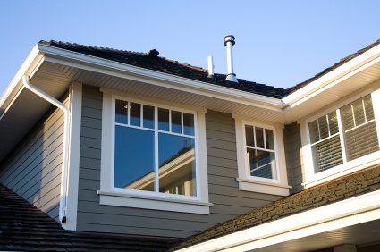 A house with a lot of windows and a chimney on the roof