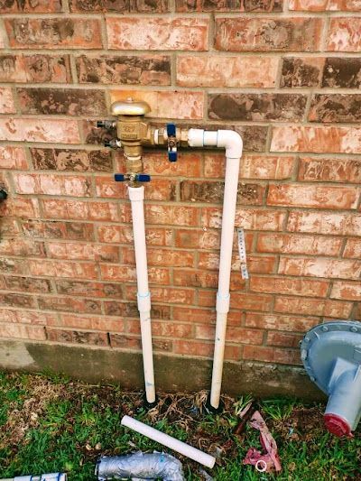 A brick wall with a hose attached to it.