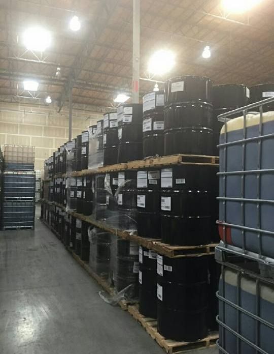 A warehouse filled with lots of barrels and containers