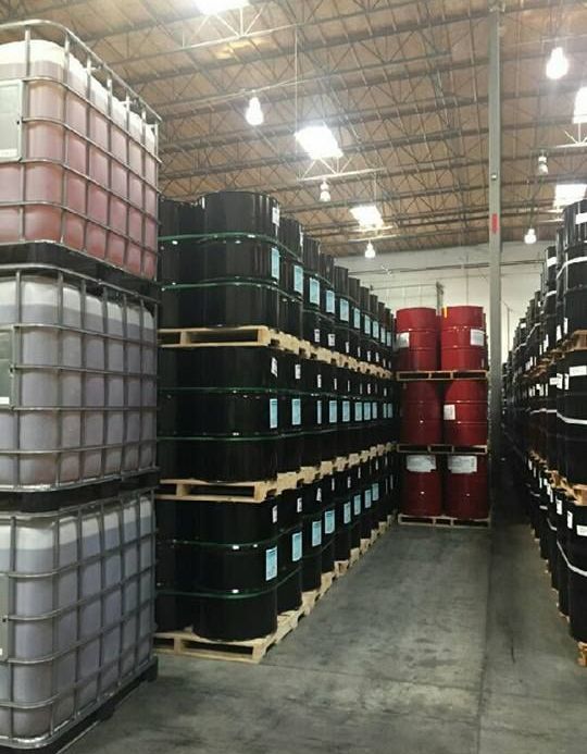 A warehouse filled with lots of barrels and containers