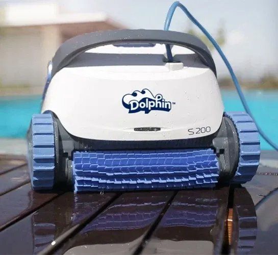 A dolphin s200 robotic pool cleaner is sitting on a wooden deck