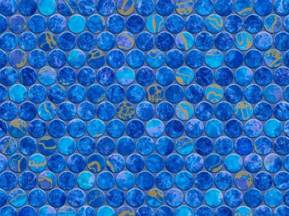 A close up of a blue mosaic tile wall.