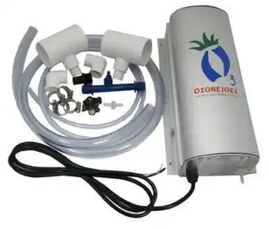 A ozone generator is sitting next to a bunch of hose and connectors.