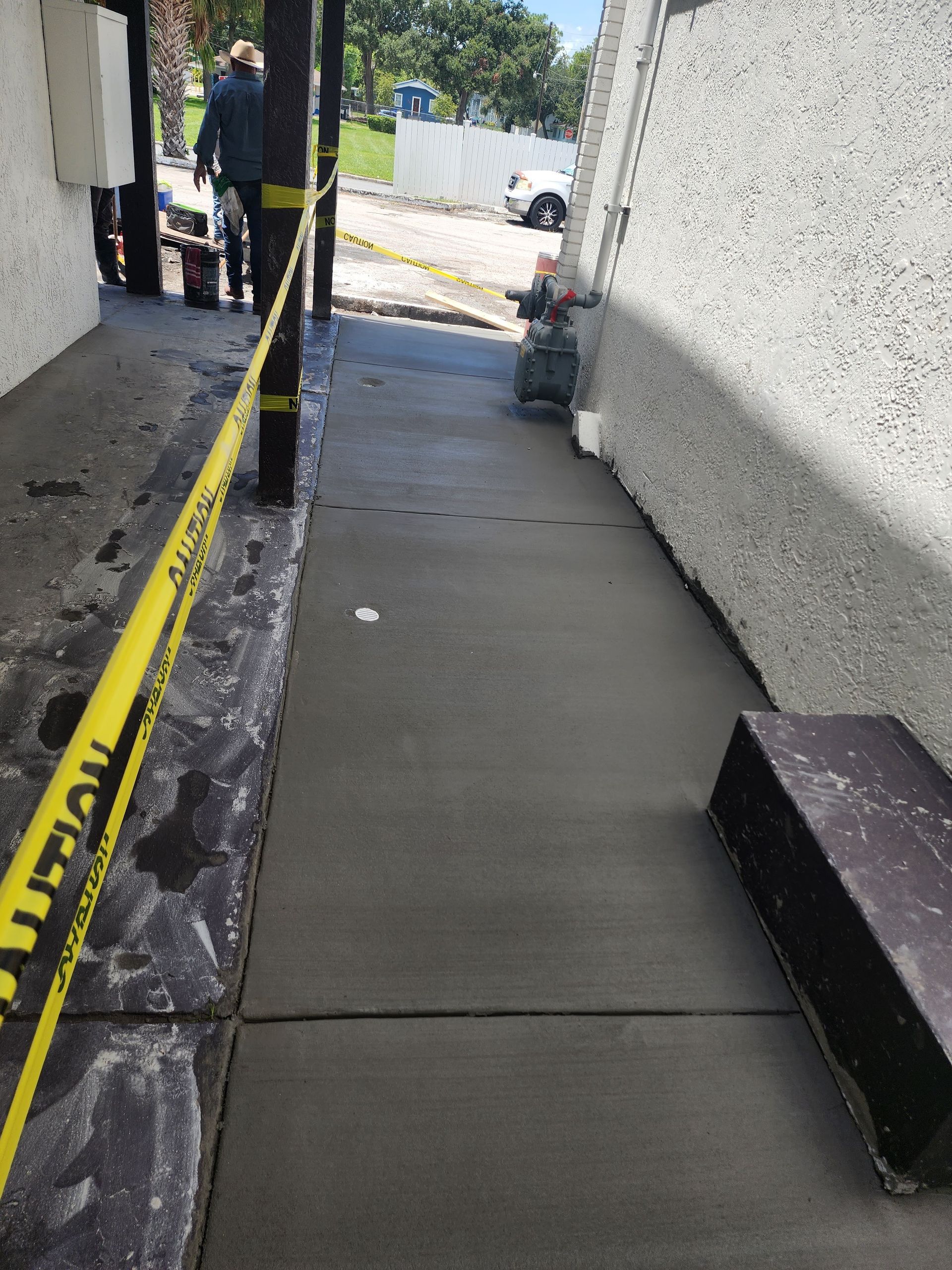 A sidewalk with a yellow caution tape around it