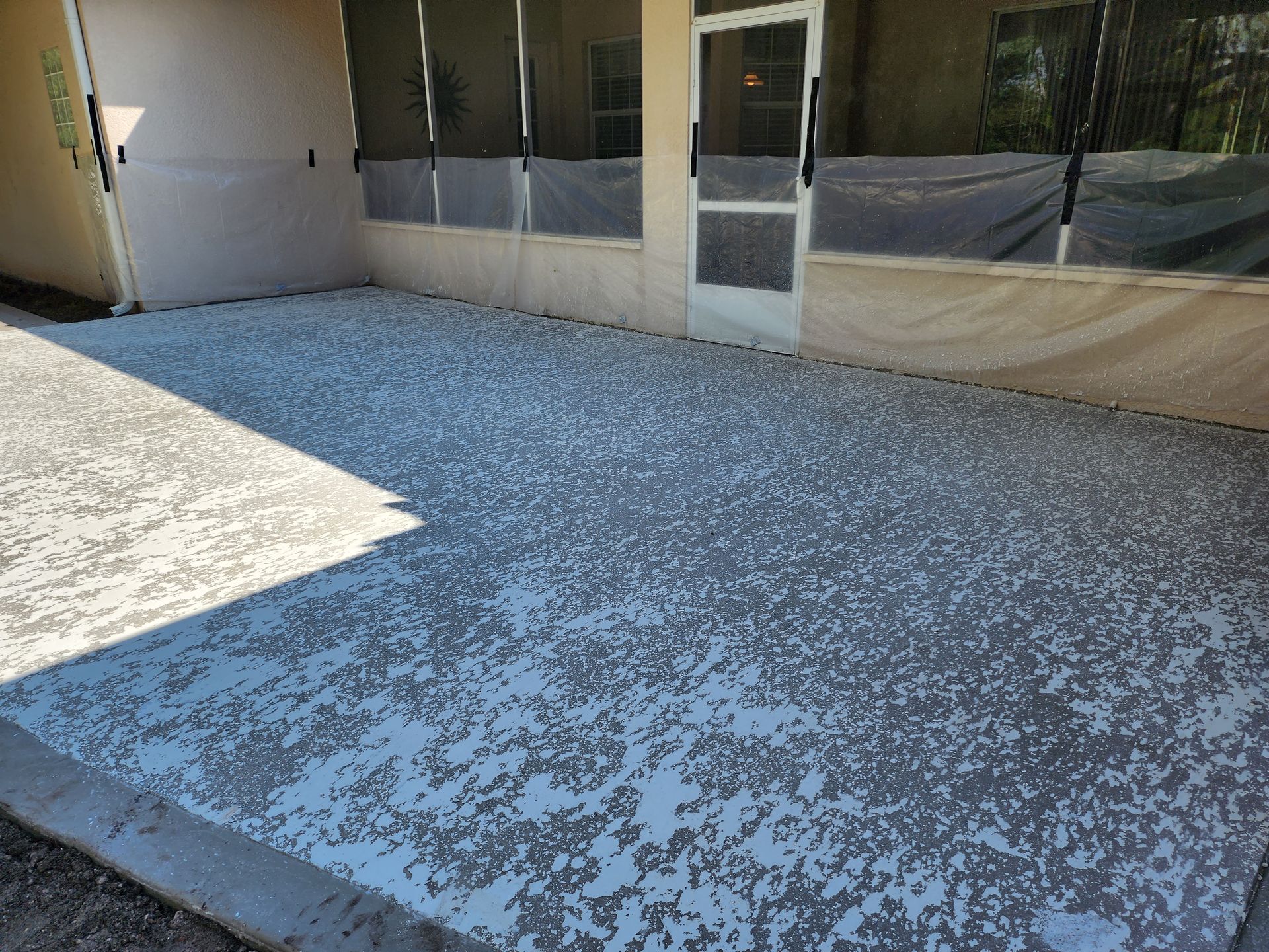 A gray and white concrete floor in front of a building