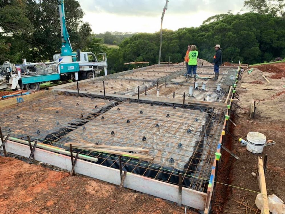 Construction Site With Workers Pouring Concrete for a Foundation — JGD Constructions in Lake Eacham, QLD